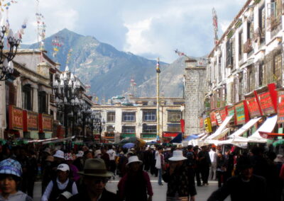 A Crowd Of People Walking In A Street