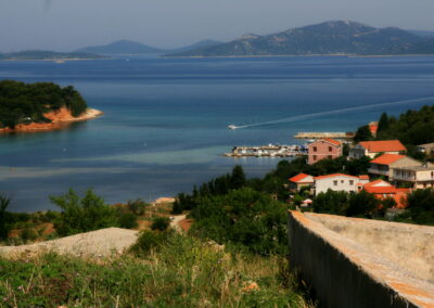 A Body Of Water With Houses And Trees