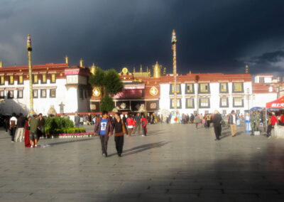 A Group Of People Walking In A Courtyard