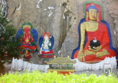 A Painting Of Buddhas On A Rock